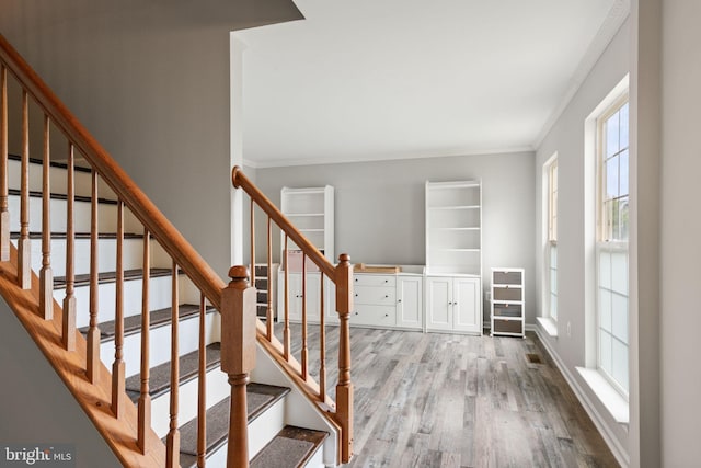 9235 Stephanie St, Manassas Park, VA 20111 - stairway featuring wood finished floors, ornamental molding, and baseboards