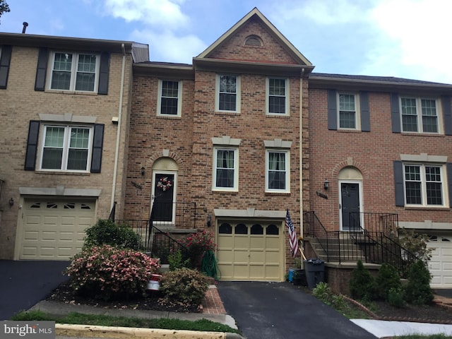 7709 Gromwell Ct, Springfield, VA 22152 - townhome / multi-family property featuring a garage, driveway, and brick siding