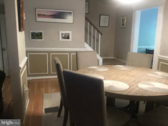 7709 Gromwell Ct, Springfield, VA 22152 - dining room featuring wood finished floors, stairs, and a decorative wall