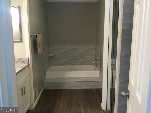 7709 Gromwell Ct, Springfield, VA 22152 - bathroom featuring wood finished floors, a tub to relax in, and vanity