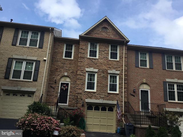 7709 Gromwell Ct, Springfield, VA 22152 - view of property featuring a garage, brick siding, and driveway