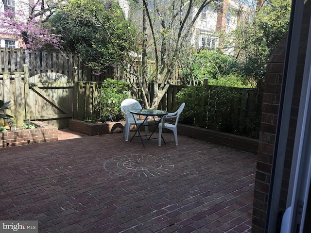 7709 Gromwell Ct, Springfield, VA 22152 - fenced backyard featuring a patio, a gate, and outdoor dining area