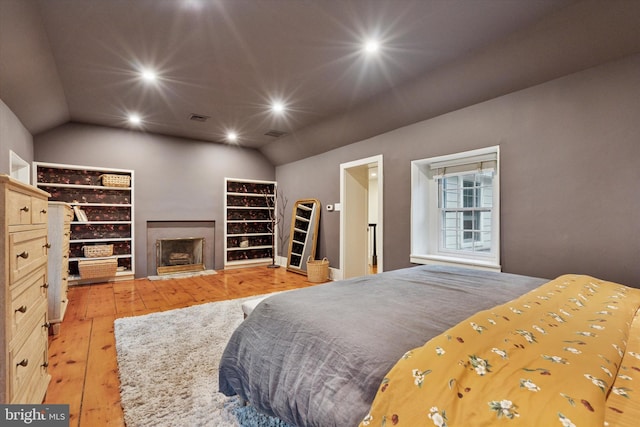2320 Turk Rd, Doylestown, PA 18901 - bedroom featuring lofted ceiling, light wood finished floors, recessed lighting, and a fireplace