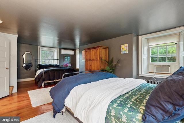 2320 Turk Rd, Doylestown, PA 18901 - bedroom featuring wood finished floors, cooling unit, radiator, an AC wall unit, and baseboards