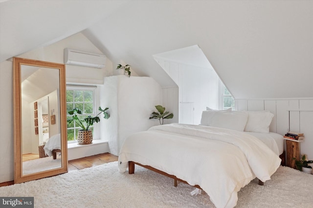 2320 Turk Rd, Doylestown, PA 18901 - bedroom featuring a wall unit AC, vaulted ceiling, and wood finished floors