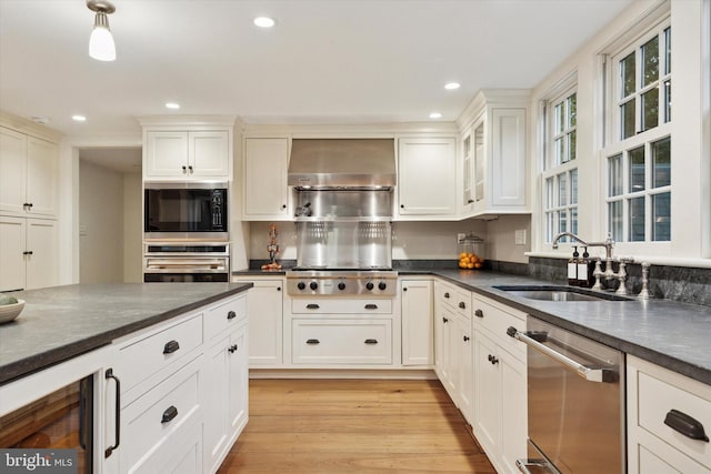 2320 Turk Rd, Doylestown, PA 18901 - kitchen with stainless steel appliances, wall chimney exhaust hood, a sink, beverage cooler, and light wood-style floors