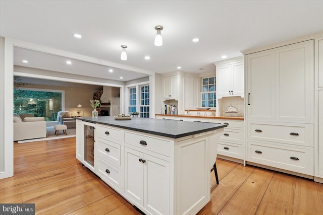 2320 Turk Rd, Doylestown, PA 18901 - kitchen featuring wine cooler, dark countertops, recessed lighting, a center island, and light wood-type flooring