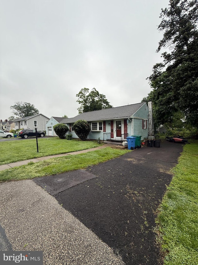 2225 Palmer Ave, Bristol, PA 19007 - view of front facade featuring a front lawn and driveway