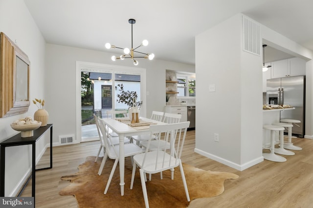 13803 Lionel Ln, Rockville, MD 20853 - dining area featuring a chandelier, light wood finished floors, and plenty of natural light