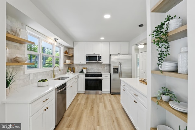 13803 Lionel Ln, Rockville, MD 20853 - kitchen with open shelves, appliances with stainless steel finishes, a sink, light wood-style floors, and white cabinetry