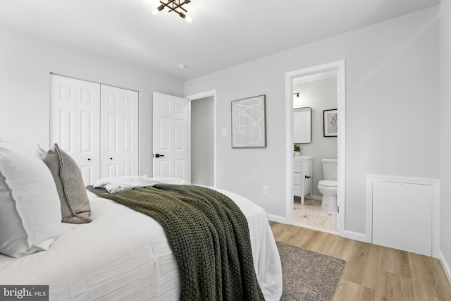 13803 Lionel Ln, Rockville, MD 20853 - bedroom with a closet, light wood-style floors, ensuite bathroom, and baseboards