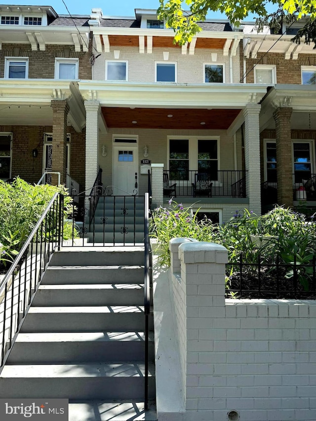 5521 4th St NW, Washington, DC 20011 - view of front of property with covered porch, brick siding, and stairs