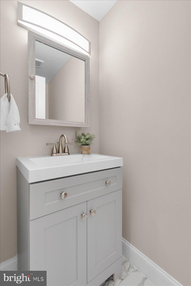 5521 4th St NW, Washington, DC 20011 - bathroom with marble look tiles, vanity, and baseboards