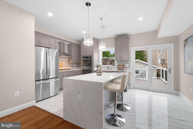 5521 4th St NW, Washington, DC 20011 - kitchen featuring appliances with stainless steel finishes, gray cabinets, wall chimney range hood, light marble finish flooring, and baseboards