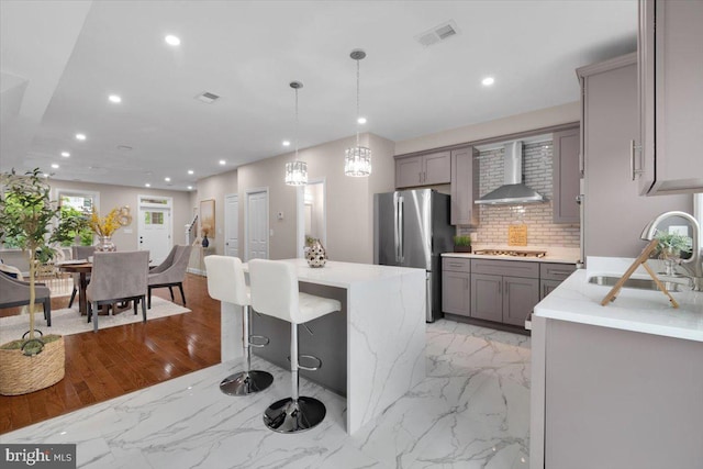 5521 4th St NW, Washington, DC 20011 - kitchen with gray cabinetry, appliances with stainless steel finishes, a sink, wall chimney range hood, and recessed lighting
