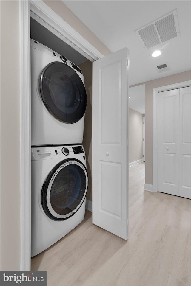5521 4th St NW, Washington, DC 20011 - laundry area featuring stacked washer and clothes dryer, light wood-type flooring, baseboards, and recessed lighting