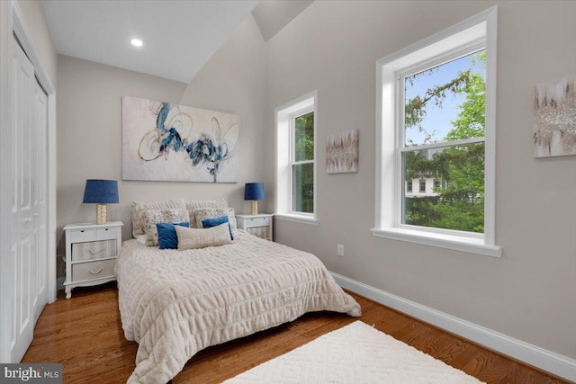 5521 4th St NW, Washington, DC 20011 - bedroom featuring baseboards, wood finished floors, a closet, and lofted ceiling