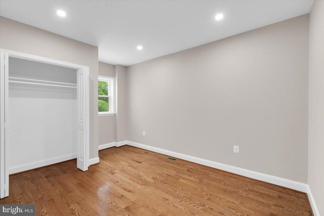5521 4th St NW, Washington, DC 20011 - unfurnished bedroom with baseboards, wood finished floors, recessed lighting, and a closet