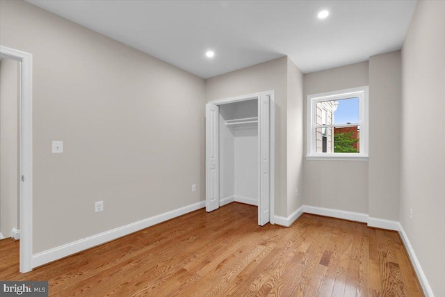 5521 4th St NW, Washington, DC 20011 - unfurnished bedroom with light wood-style flooring, baseboards, recessed lighting, and a closet