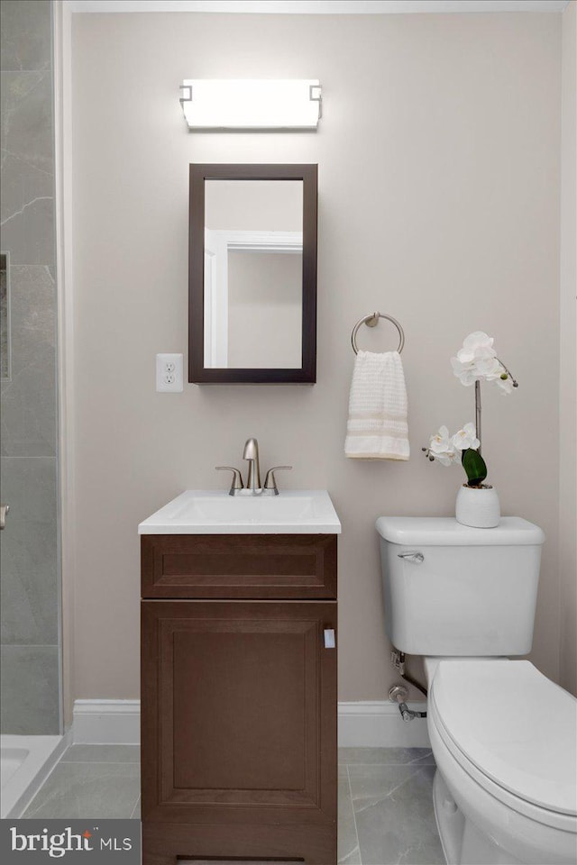 5521 4th St NW, Washington, DC 20011 - bathroom with toilet, vanity, marble finish floors, baseboards, and a tile shower