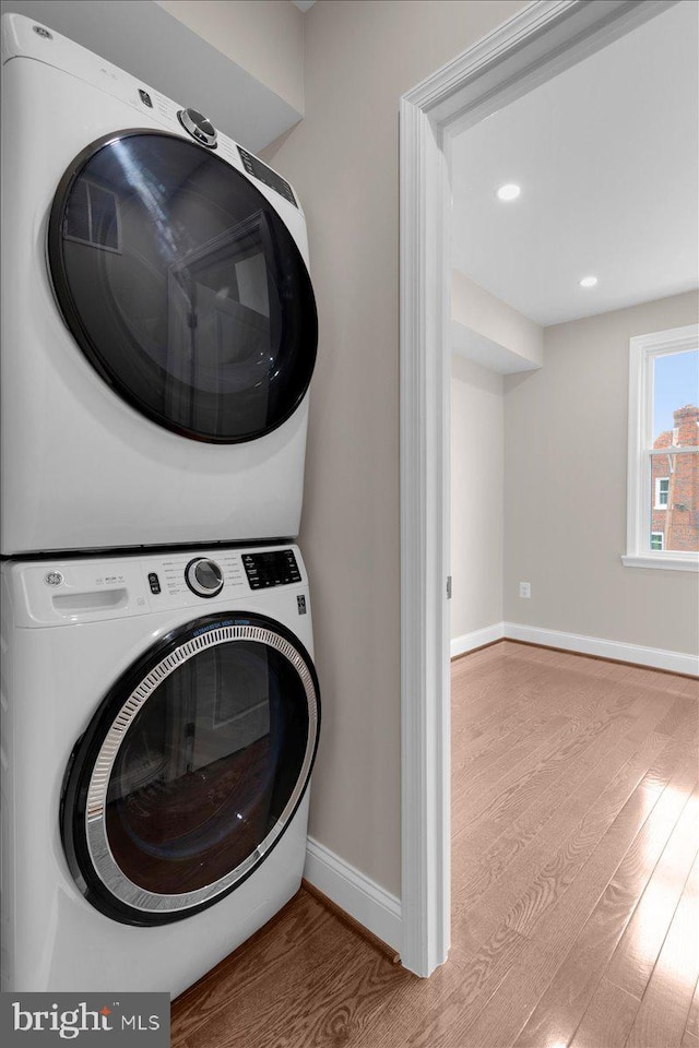 5521 4th St NW, Washington, DC 20011 - laundry room featuring stacked washer / dryer, wood finished floors, baseboards, and recessed lighting