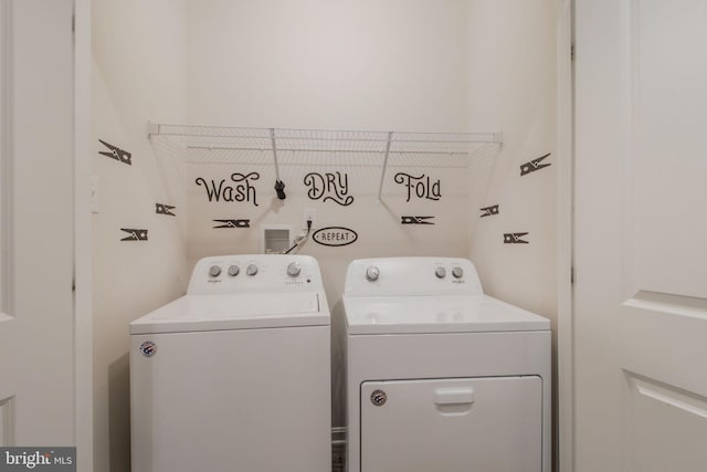 clothes washing area with washer and dryer