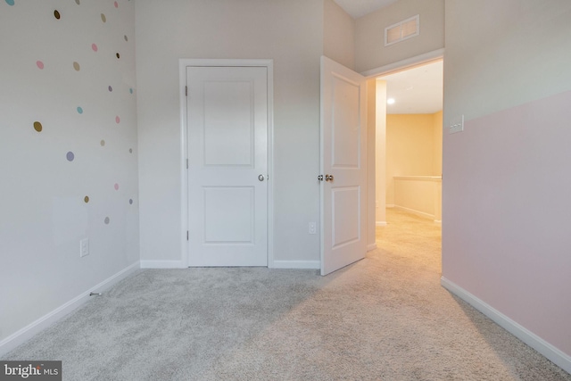 unfurnished bedroom featuring carpet floors and baseboards