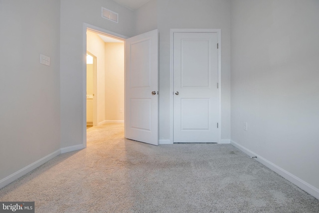 unfurnished bedroom featuring carpet flooring and baseboards