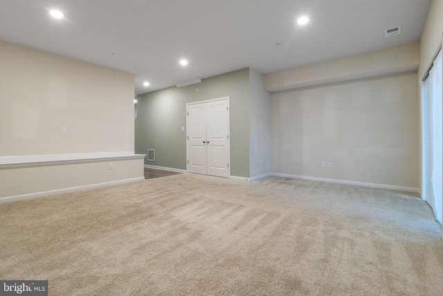 unfurnished room with carpet floors, recessed lighting, and baseboards