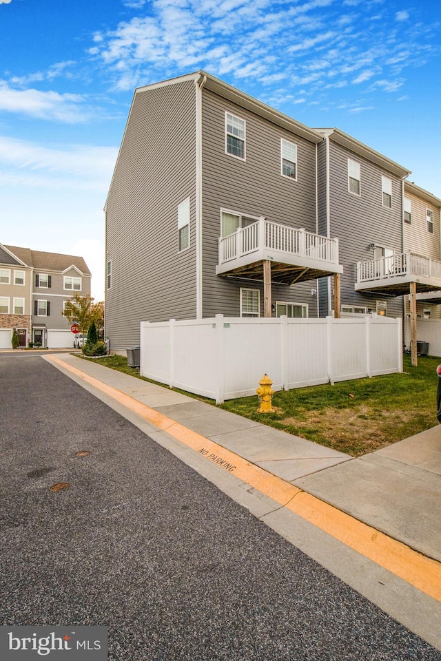 view of front of home with fence and cooling unit