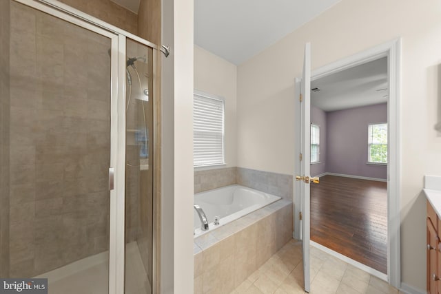 111 Carnoustie, Stephens City, VA 22655 - full bathroom featuring a garden tub, vanity, a stall shower, and tile patterned floors