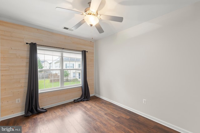 111 Carnoustie, Stephens City, VA 22655 - empty room featuring wood walls, dark wood-type flooring, baseboards, and a ceiling fan