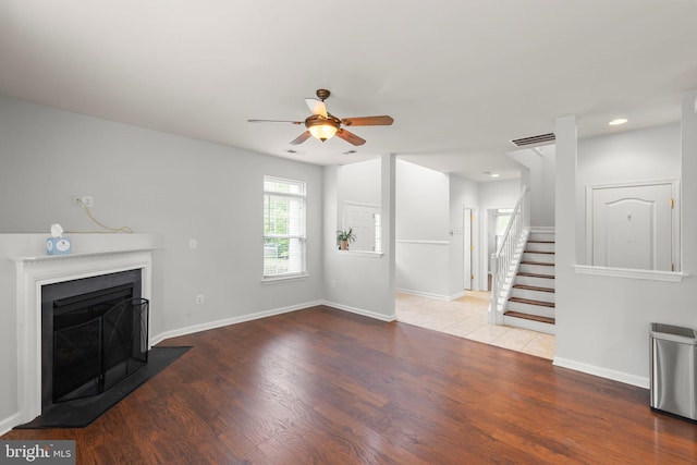 111 Carnoustie, Stephens City, VA 22655 - unfurnished living room with a ceiling fan, wood finished floors, a fireplace with flush hearth, stairway, and recessed lighting