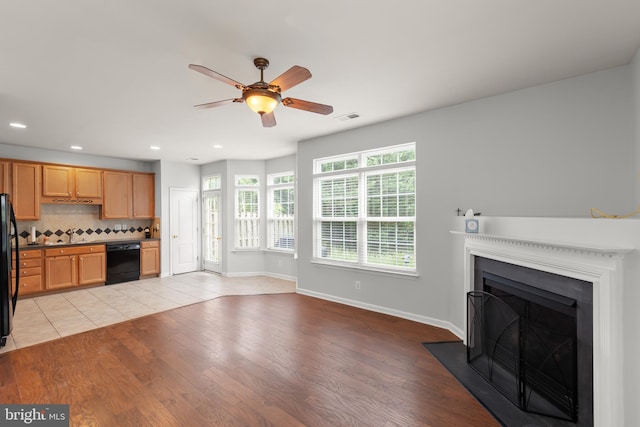 111 Carnoustie, Stephens City, VA 22655 - unfurnished living room with ceiling fan, light wood-style flooring, recessed lighting, a fireplace with flush hearth, and a sink