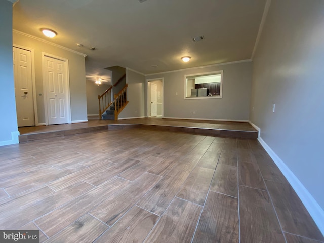 12625 Kempston Ln, Woodbridge, VA 22192 - unfurnished living room featuring ornamental molding, stairway, wood finished floors, and baseboards