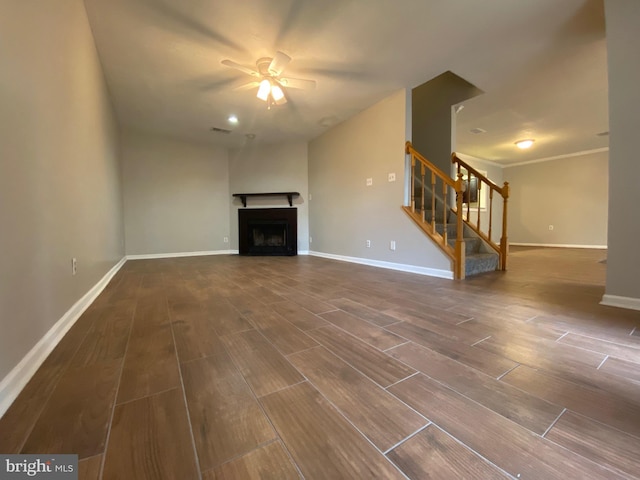 12625 Kempston Ln, Woodbridge, VA 22192 - unfurnished living room with stairway, wood finished floors, a ceiling fan, a fireplace, and baseboards