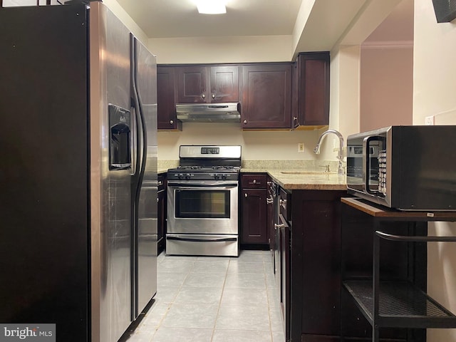 12625 Kempston Ln, Woodbridge, VA 22192 - kitchen featuring stainless steel appliances, under cabinet range hood, a sink, light tile patterned flooring, and light stone counters