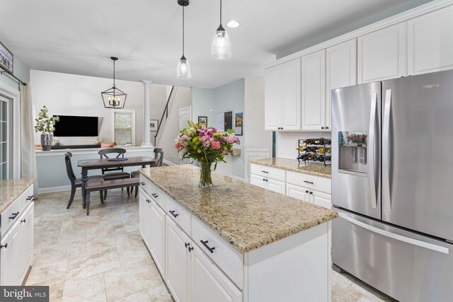 13 Richland Dr, Mount Laurel, NJ 08054 - kitchen featuring stainless steel fridge, white cabinets, backsplash, a center island, and light stone counters