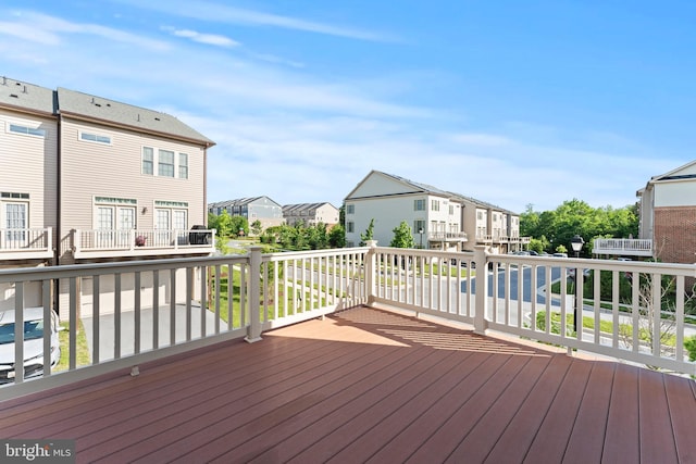 wooden terrace featuring a residential view