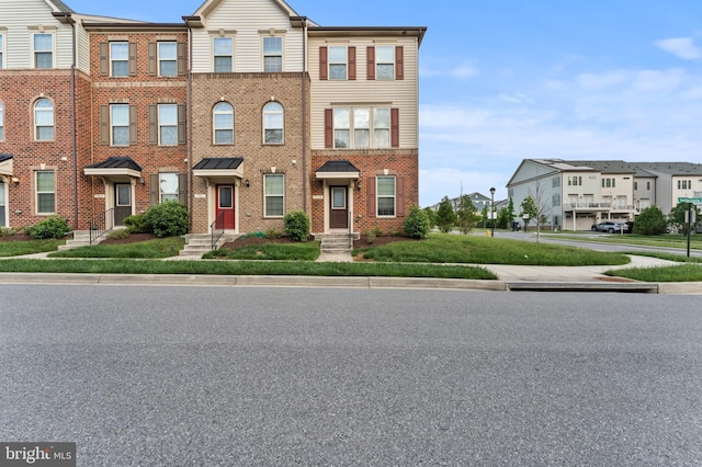view of property with brick siding and a residential view