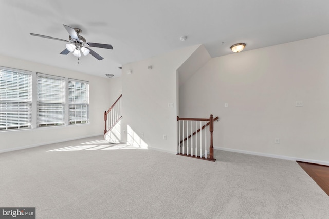 unfurnished room featuring carpet flooring, baseboards, and ceiling fan
