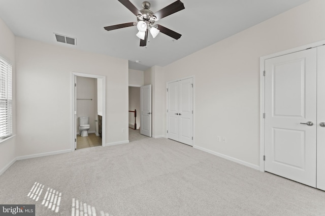 unfurnished bedroom with multiple windows, carpet floors, and baseboards