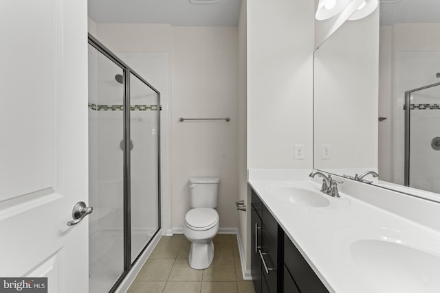 full bathroom with tile patterned flooring, a stall shower, toilet, double vanity, and baseboards