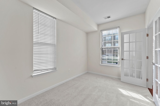 unfurnished bedroom with carpet floors, french doors, and baseboards