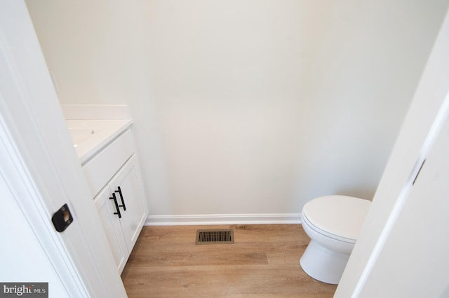 203 N First St, Greenwood, DE 19950 - bathroom featuring vanity, wood finished floors, toilet, and baseboards
