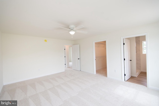 203 N First St, Greenwood, DE 19950 - unfurnished bedroom featuring light colored carpet, a spacious closet, baseboards, a closet, and a ceiling fan