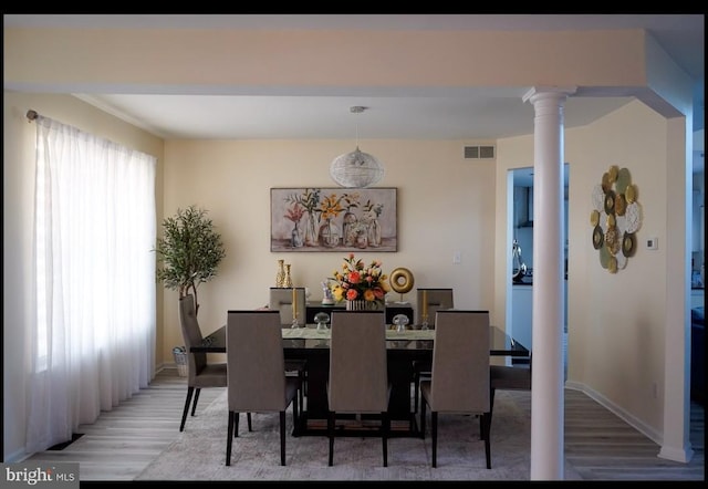 821 Streamview Ln, Vineland, NJ 08360 - dining area with wood finished floors, ornate columns, and baseboards