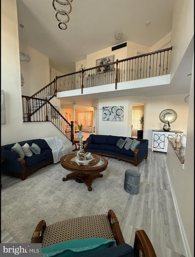 821 Streamview Ln, Vineland, NJ 08360 - living room featuring wood finished floors, stairway, a high ceiling, and baseboards
