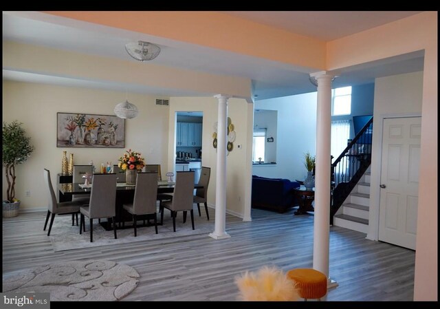 821 Streamview Ln, Vineland, NJ 08360 - dining room featuring ornate columns, wood finished floors, stairway, and baseboards