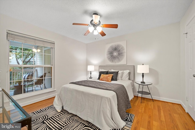 1525 Lincoln Way Unit 203, Mclean, VA 22102 - bedroom with wood finished floors, baseboards, a ceiling fan, and a textured ceiling
